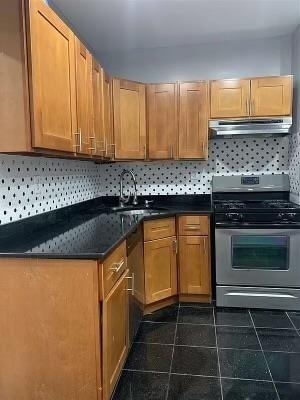 1503 76th Street, Unit 2 North Bergen, NJ 07047 - Photo 5 of 11 a kitchen with granite countertop a sink a stove and cabinets