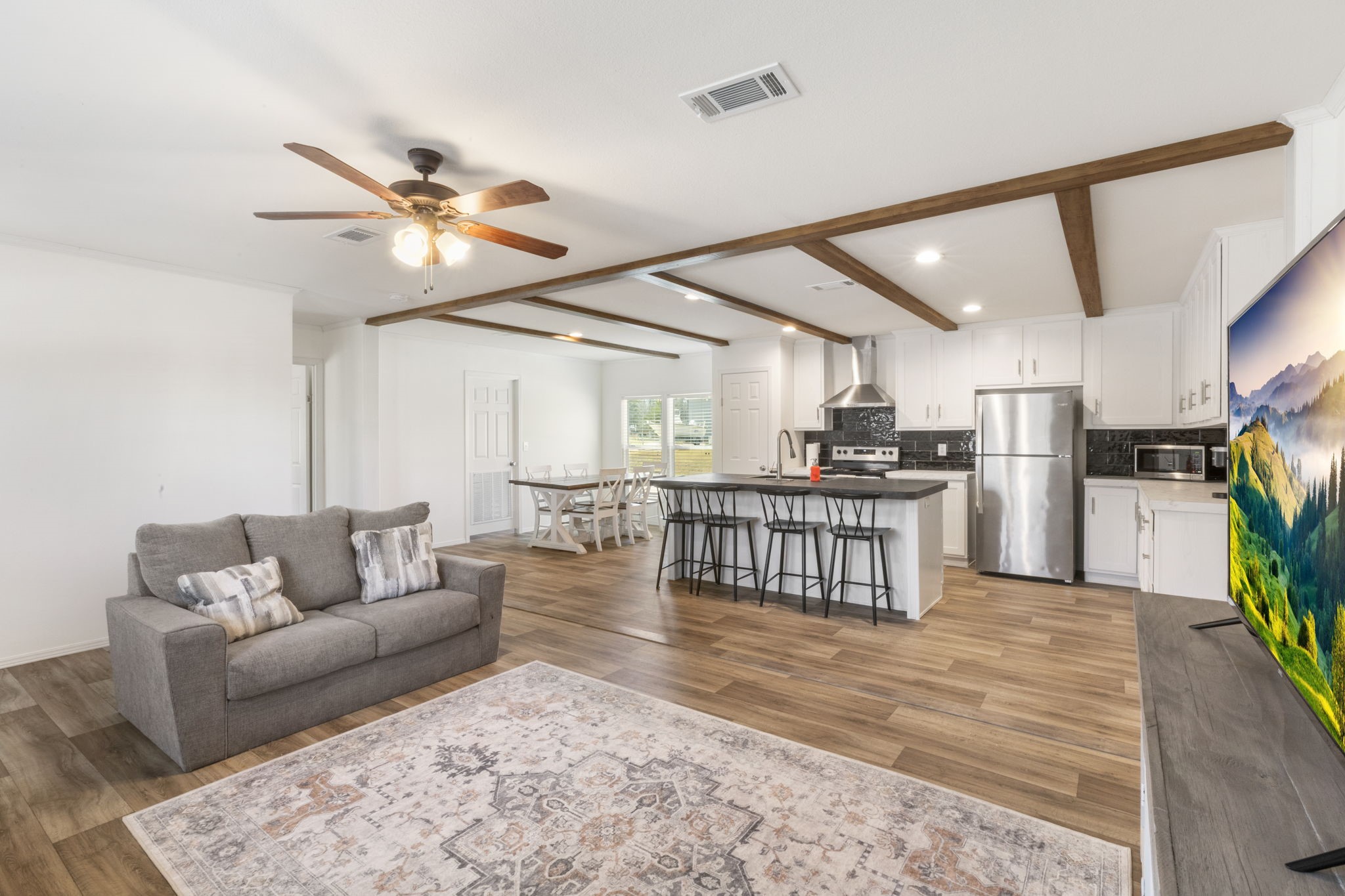 101 Hill Loop Road Somerville, TX 77879 - Photo 17 of 45 a living room with furniture kitchen view and a wooden floor