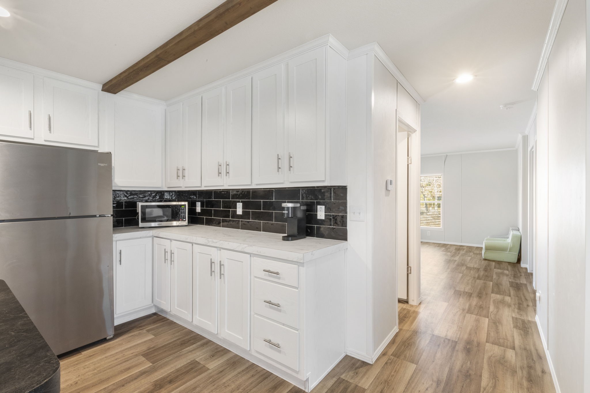 101 Hill Loop Road Somerville, TX 77879 - Photo 19 of 45 a kitchen with white cabinets and refrigerator
