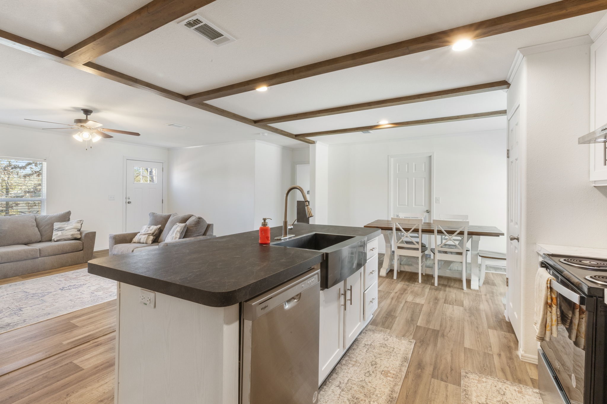 101 Hill Loop Road Somerville, TX 77879 - Photo 21 of 45 a kitchen with stainless steel appliances granite countertop a stove a sink and a refrigerator