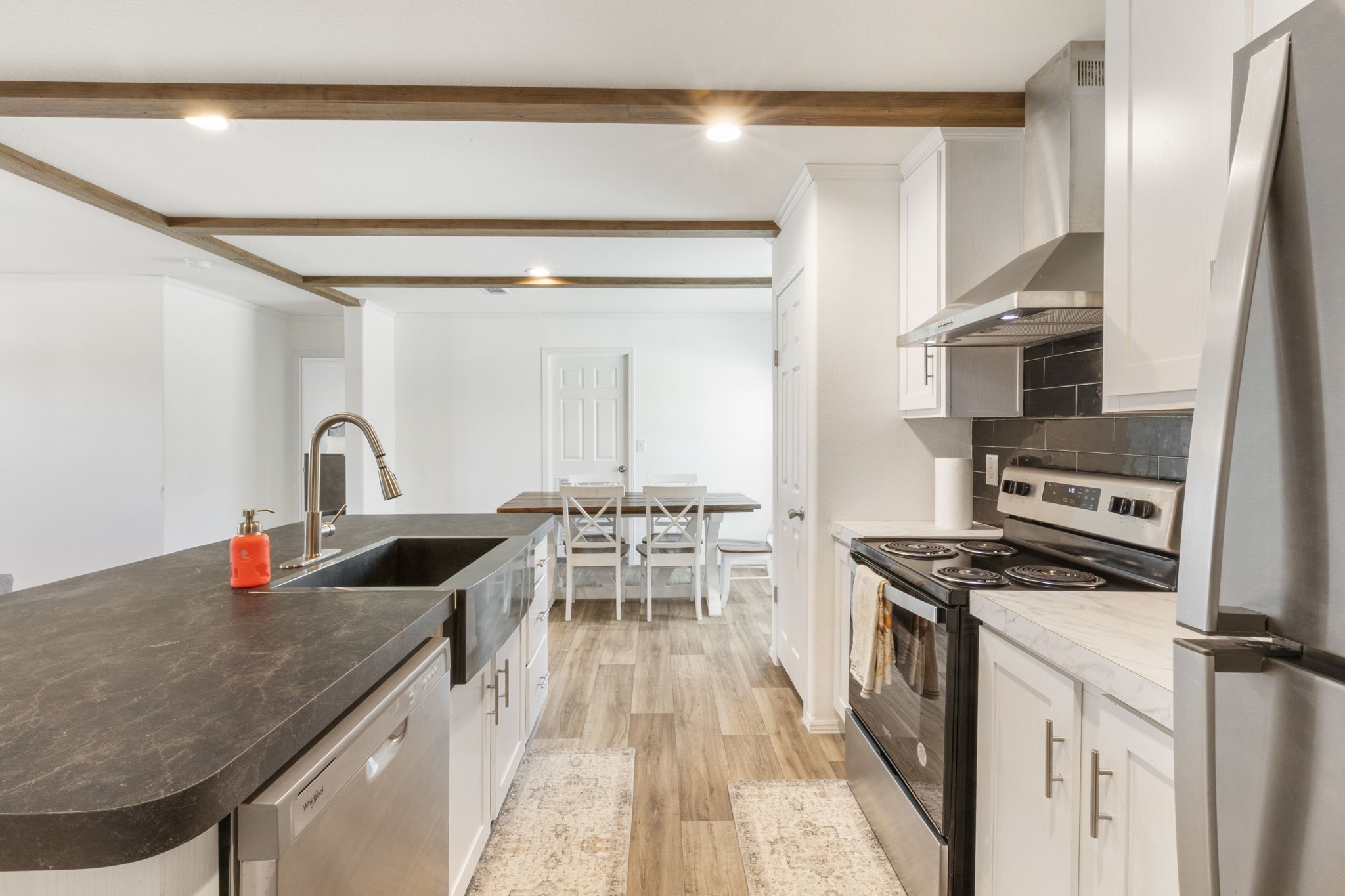 101 Hill Loop Road Somerville, TX 77879 - Photo 22 of 45 a kitchen with stainless steel appliances granite countertop a sink stove and refrigerator