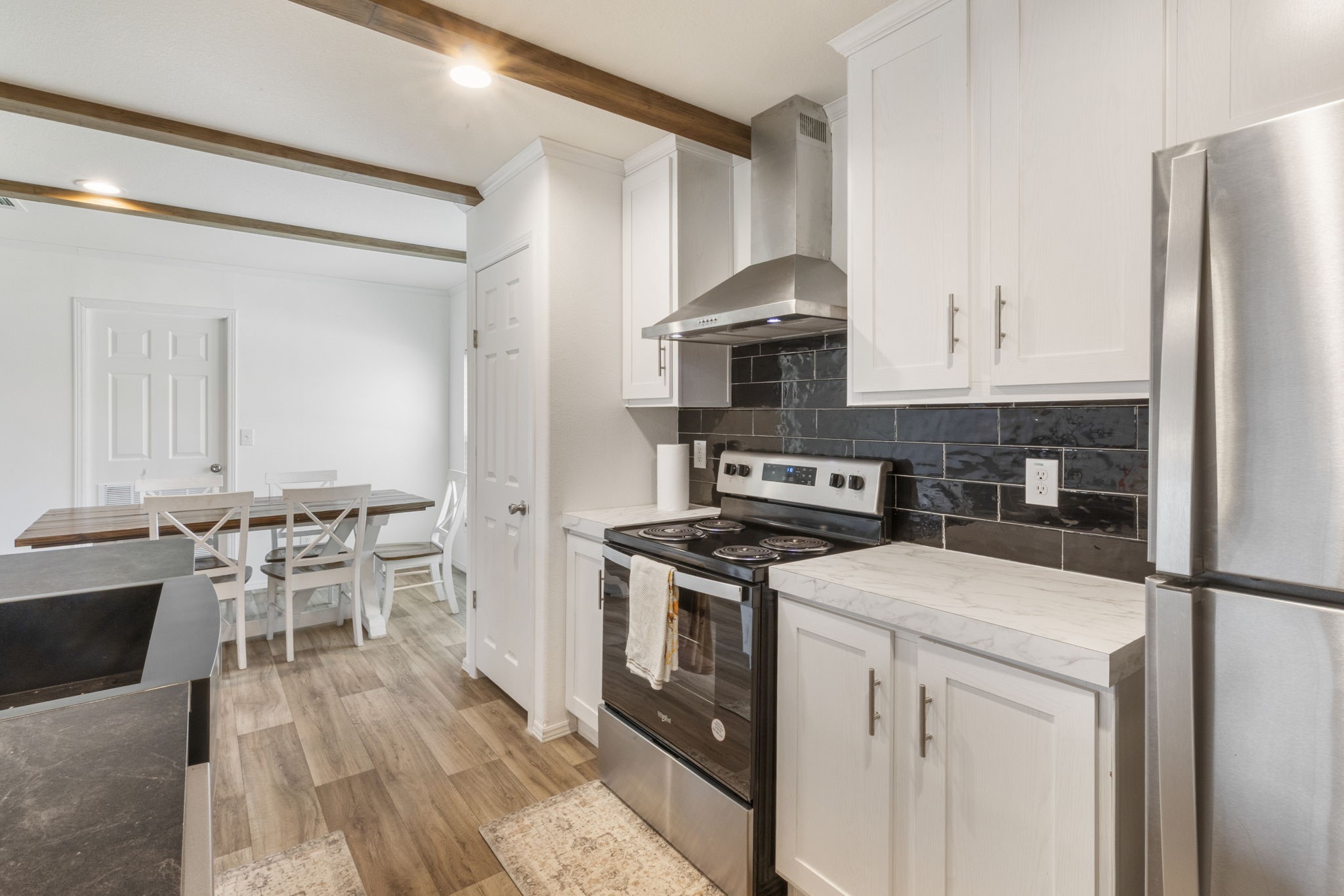 101 Hill Loop Road Somerville, TX 77879 - Photo 23 of 45 a kitchen with a stove a sink and a refrigerator