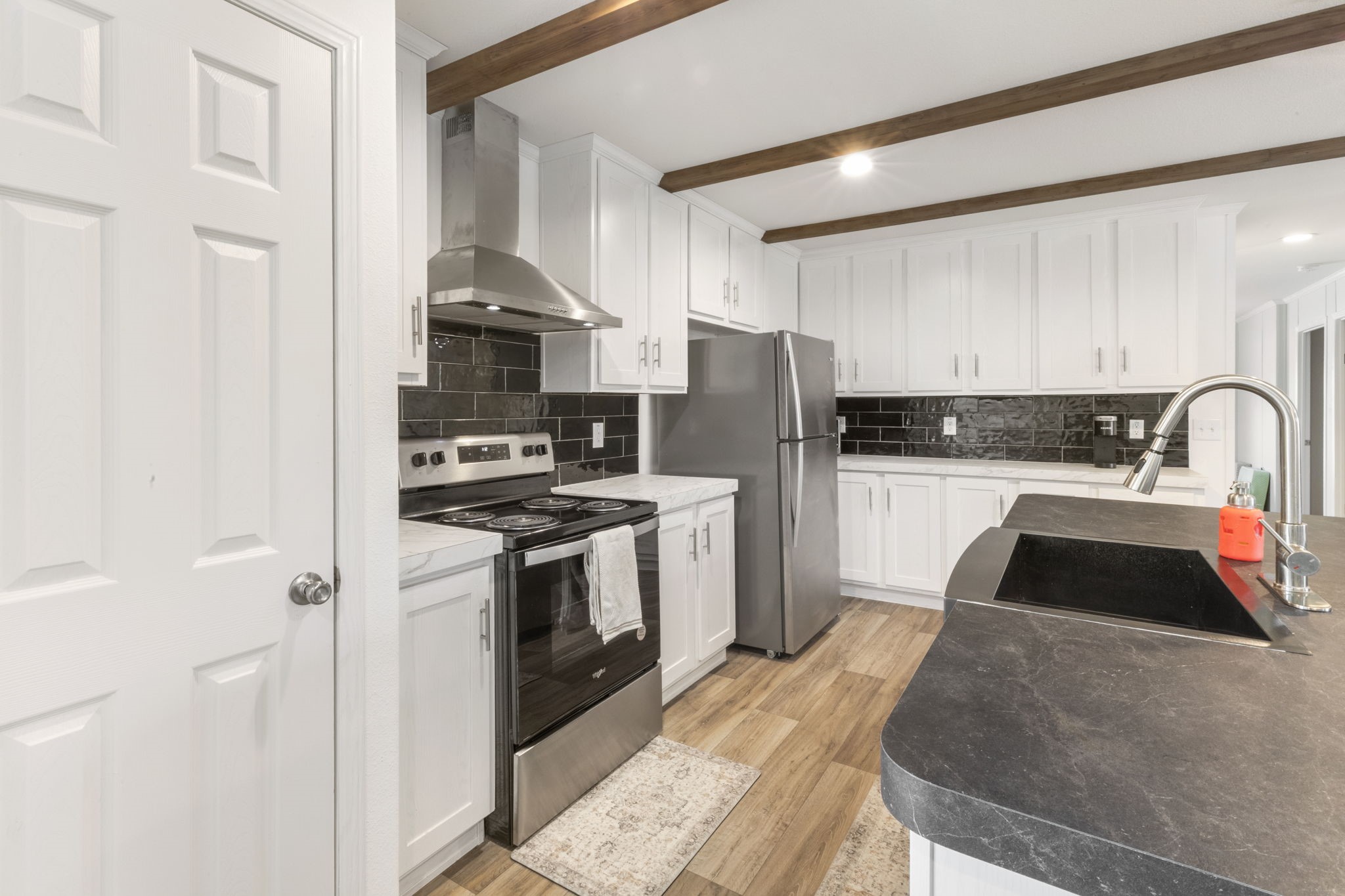 101 Hill Loop Road Somerville, TX 77879 - Photo 24 of 45 a kitchen with granite countertop a refrigerator stove and sink