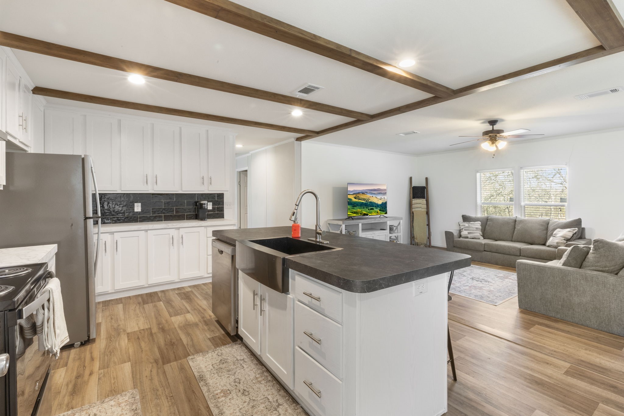 101 Hill Loop Road Somerville, TX 77879 - Photo 25 of 45 a kitchen with stainless steel appliances granite countertop a stove refrigerator and cabinets