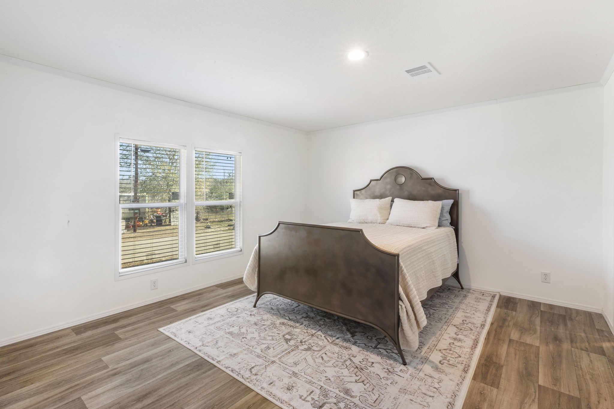 101 Hill Loop Road Somerville, TX 77879 - Photo 29 of 45 a bedroom with a bed and wooden floor
