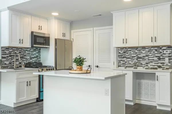 a kitchen with stainless steel appliances granite countertop a sink and cabinets