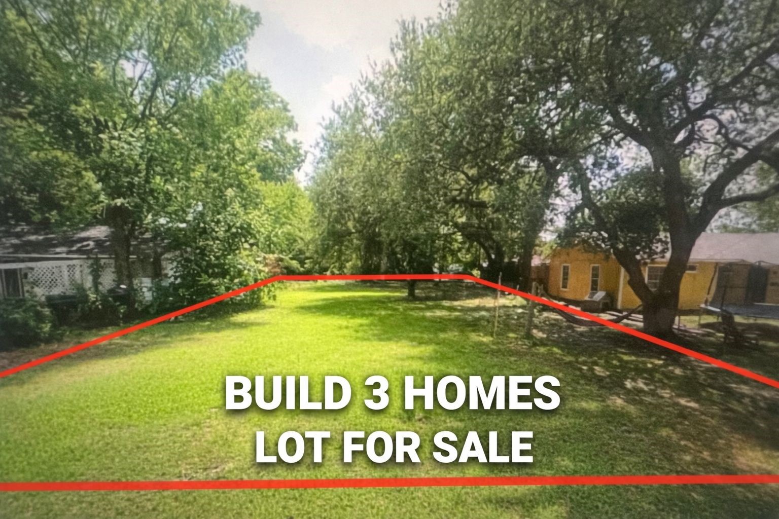 a green field with trees in front of it