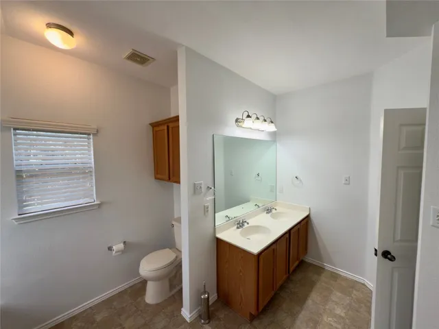 a bathroom with a sink toilet and mirror
