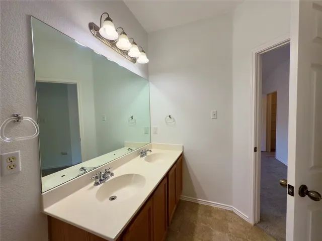 a bathroom with a sink a light fixture and a mirror