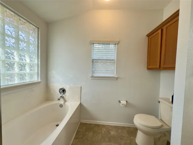 a bathroom with a toilet a sink and a bathtub