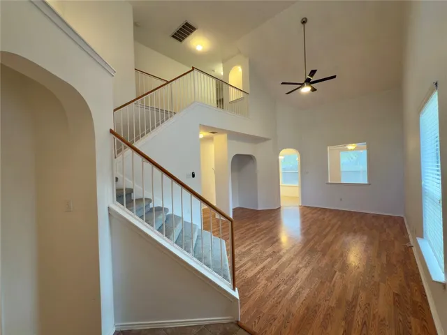 a view of entryway and hall with wooden floor