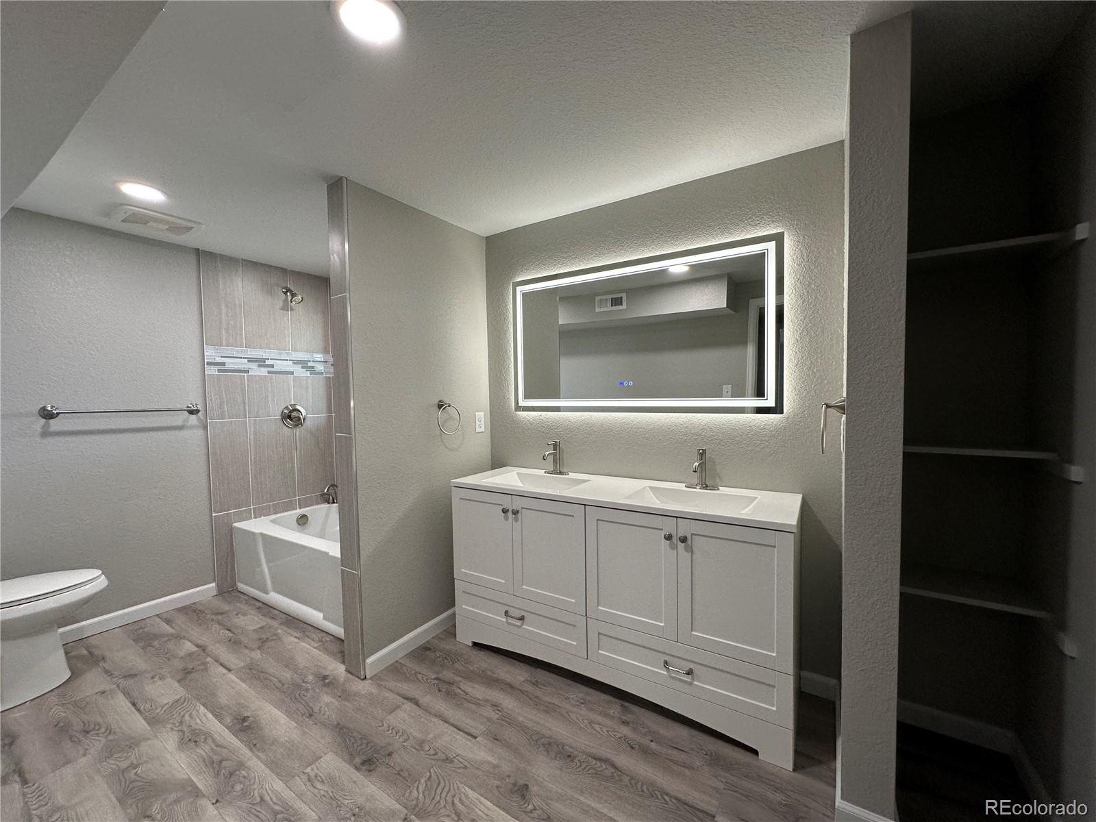 Undisclosed Address Pueblo, CO 81006 - Photo 13 of 27 a spacious bathroom with a toilet sink and mirror