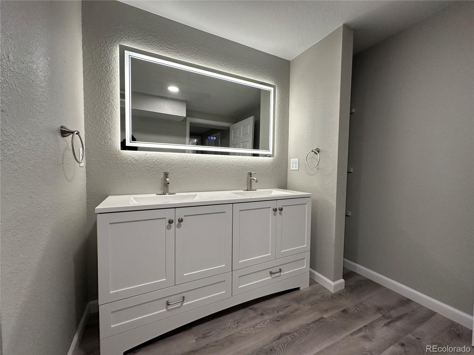 Undisclosed Address Pueblo, CO 81006 - Photo 15 of 27 a bathroom with a double vanity sink and mirror