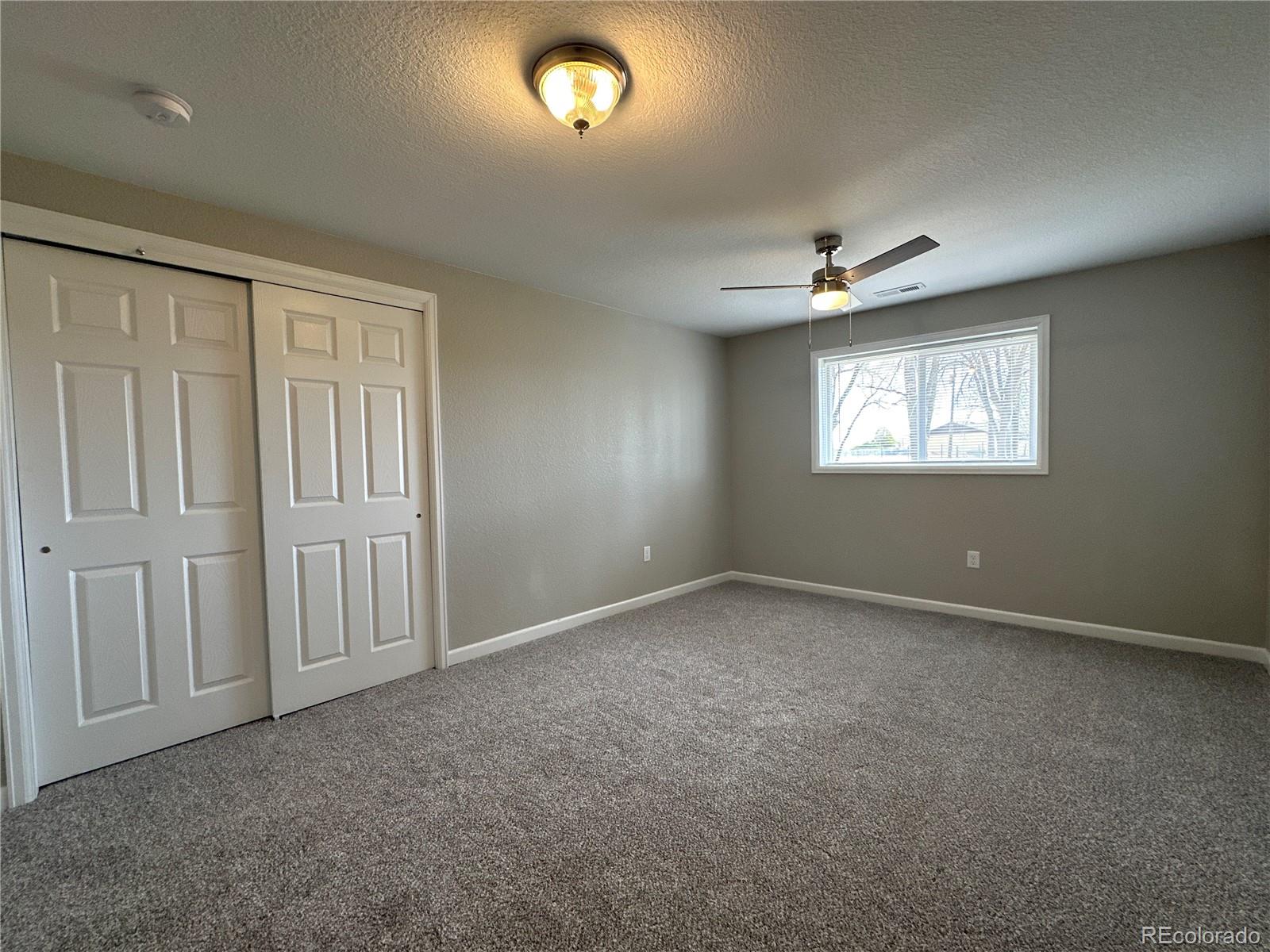 Undisclosed Address Pueblo, CO 81006 - Photo 19 of 27 an empty room with windows and ceiling fan