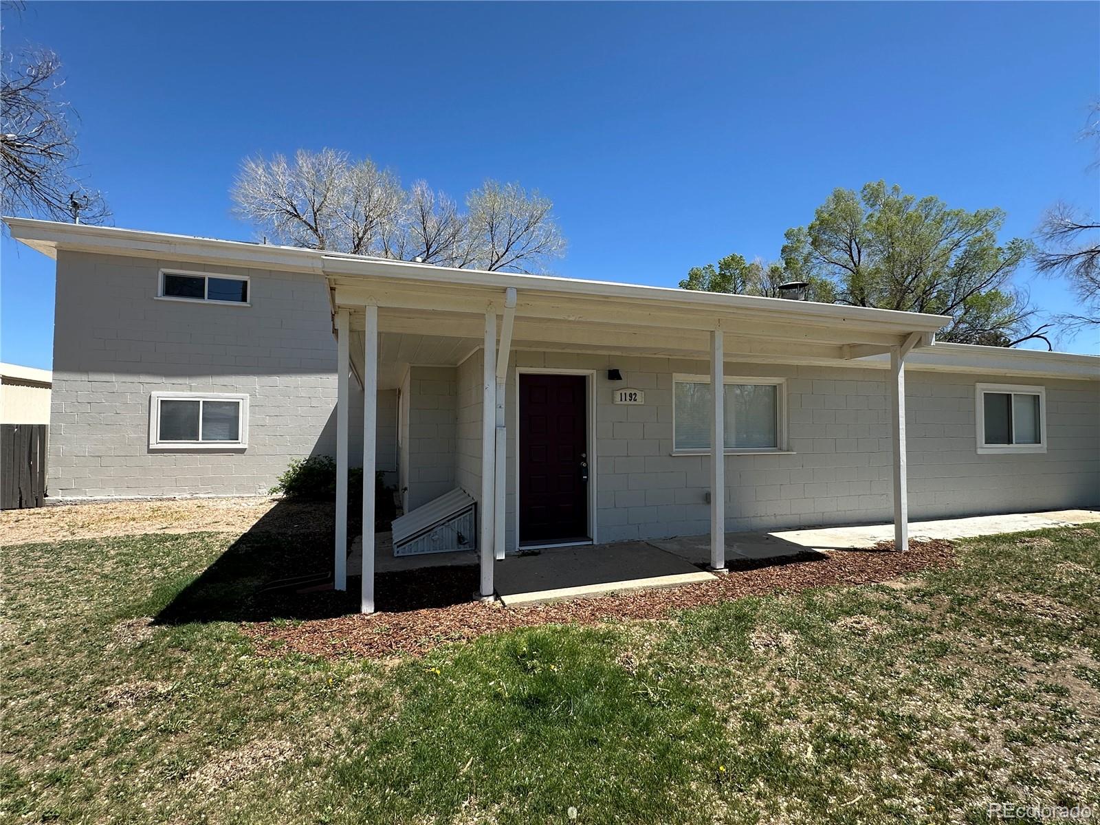 Undisclosed Address Pueblo, CO 81006 - Photo 2 of 27 front view of a house with a yard
