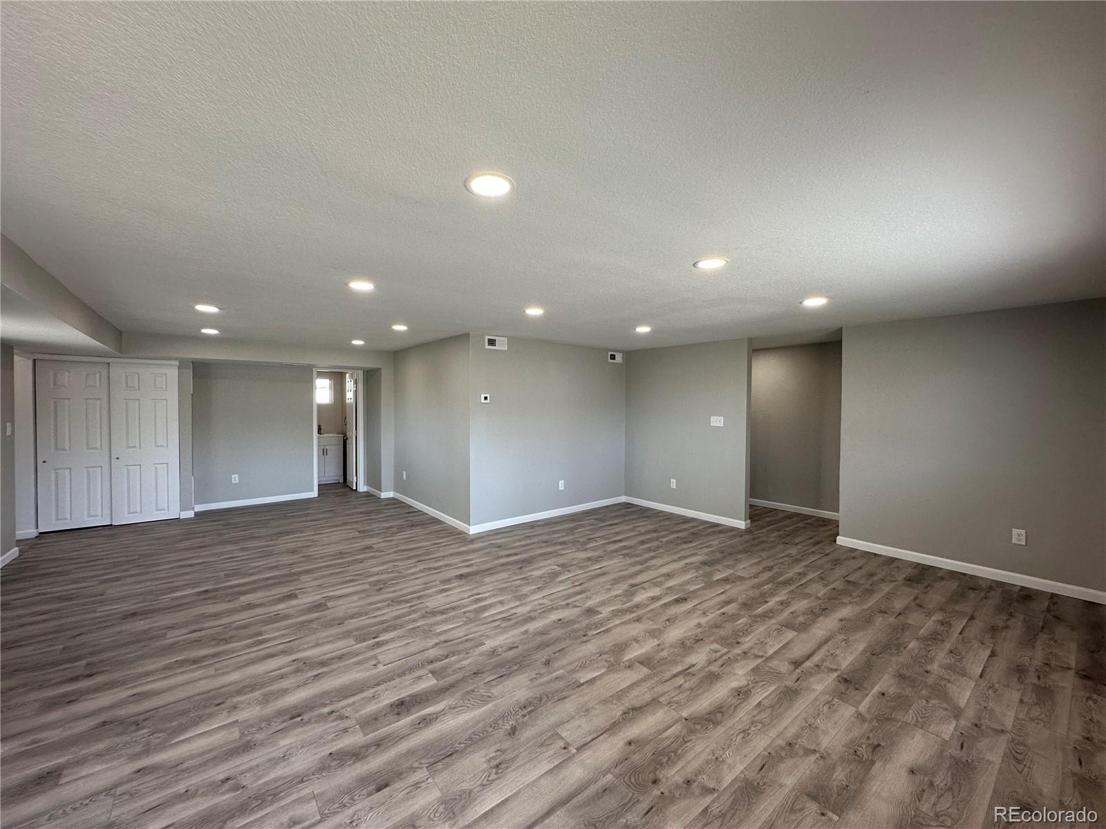 Undisclosed Address Pueblo, CO 81006 - Photo 3 of 27 an empty room with wooden floor and windows