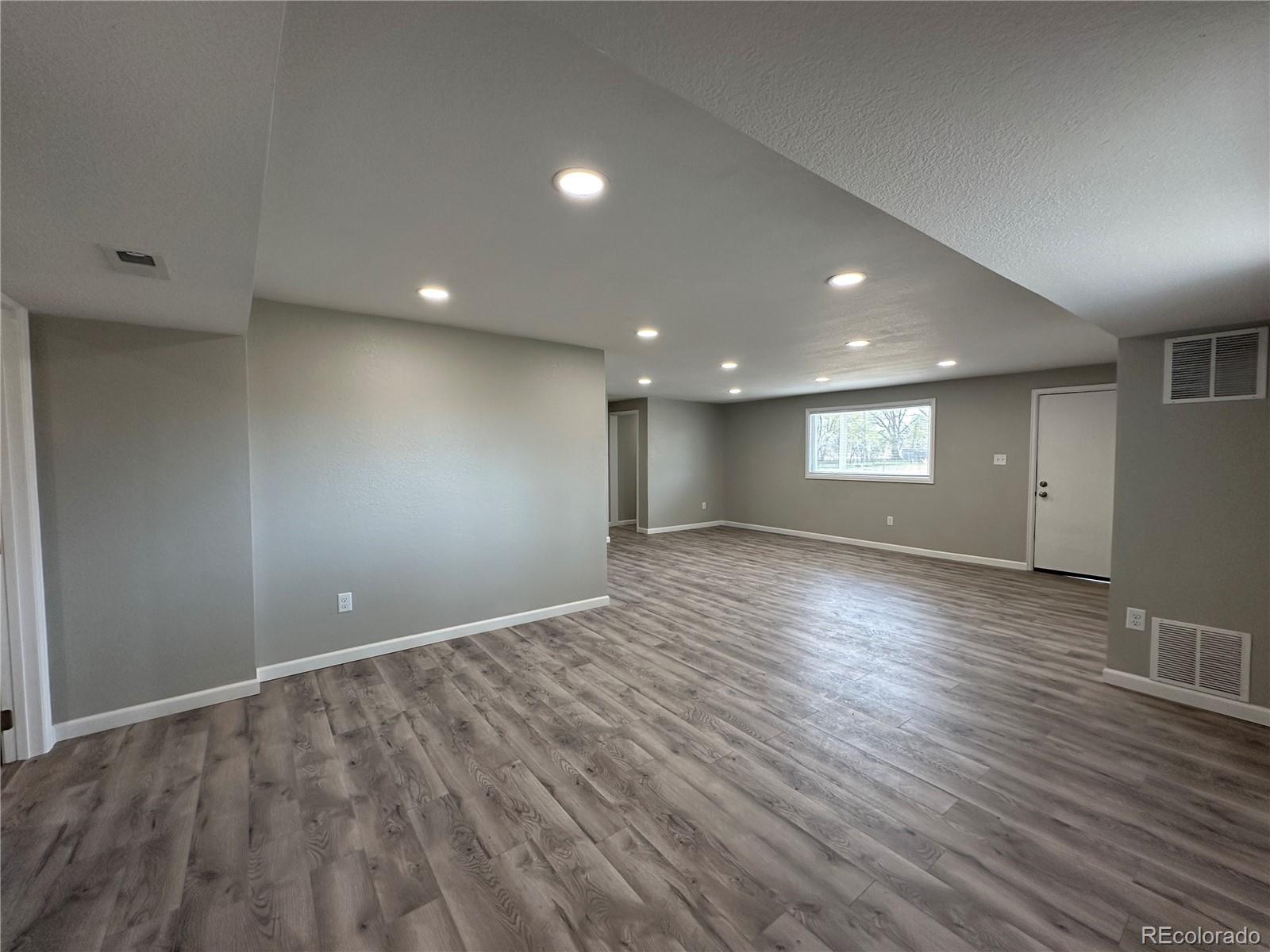 Undisclosed Address Pueblo, CO 81006 - Photo 4 of 27 an empty room with wooden floor and windows