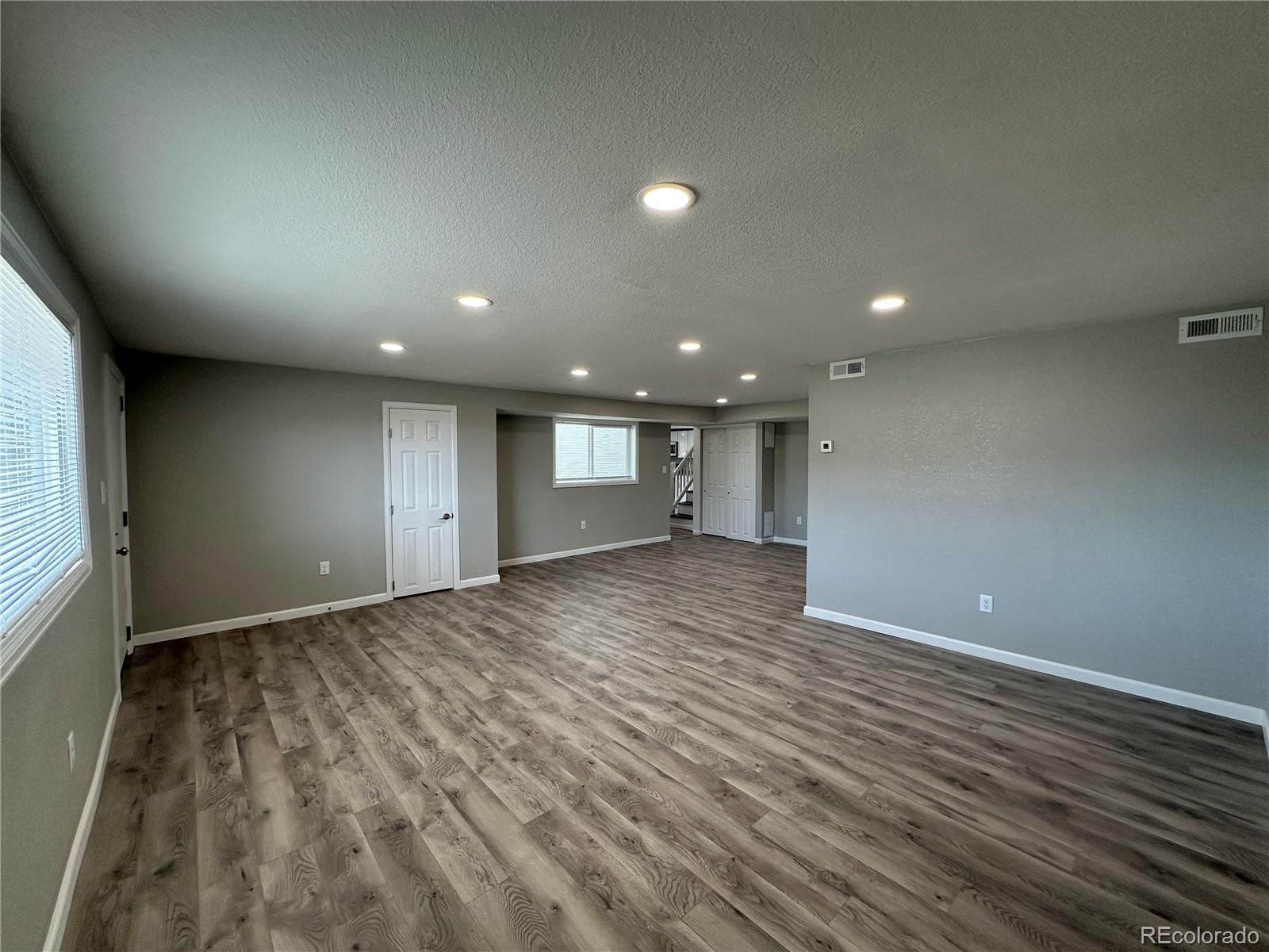 Undisclosed Address Pueblo, CO 81006 - Photo 5 of 27 an empty room with wooden floor and windows