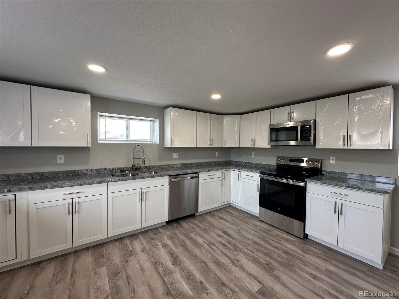 Undisclosed Address Pueblo, CO 81006 - Photo 8 of 27 a large kitchen with granite countertop a sink and cabinets