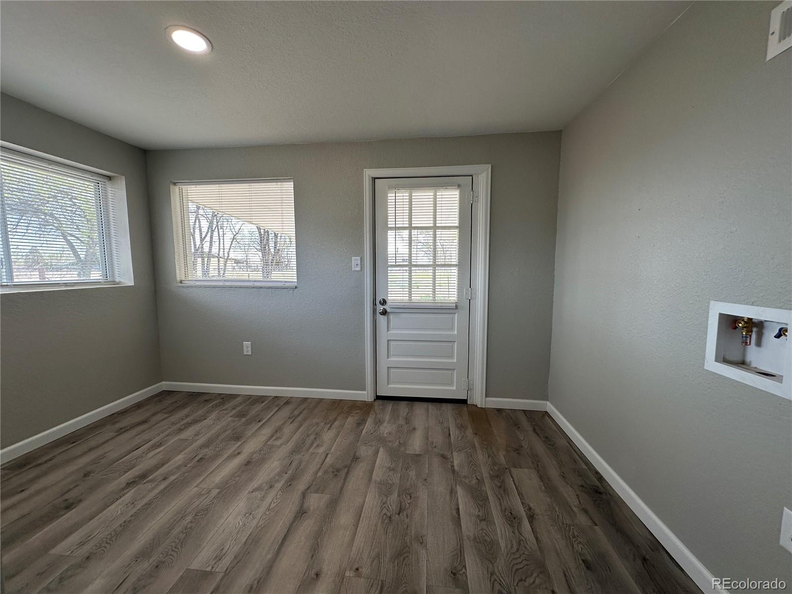 Undisclosed Address Pueblo, CO 81006 - Photo 10 of 27 a view of wooden floor and windows in a room