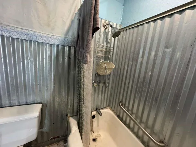 a bathroom with a toilet a sink and bathtub