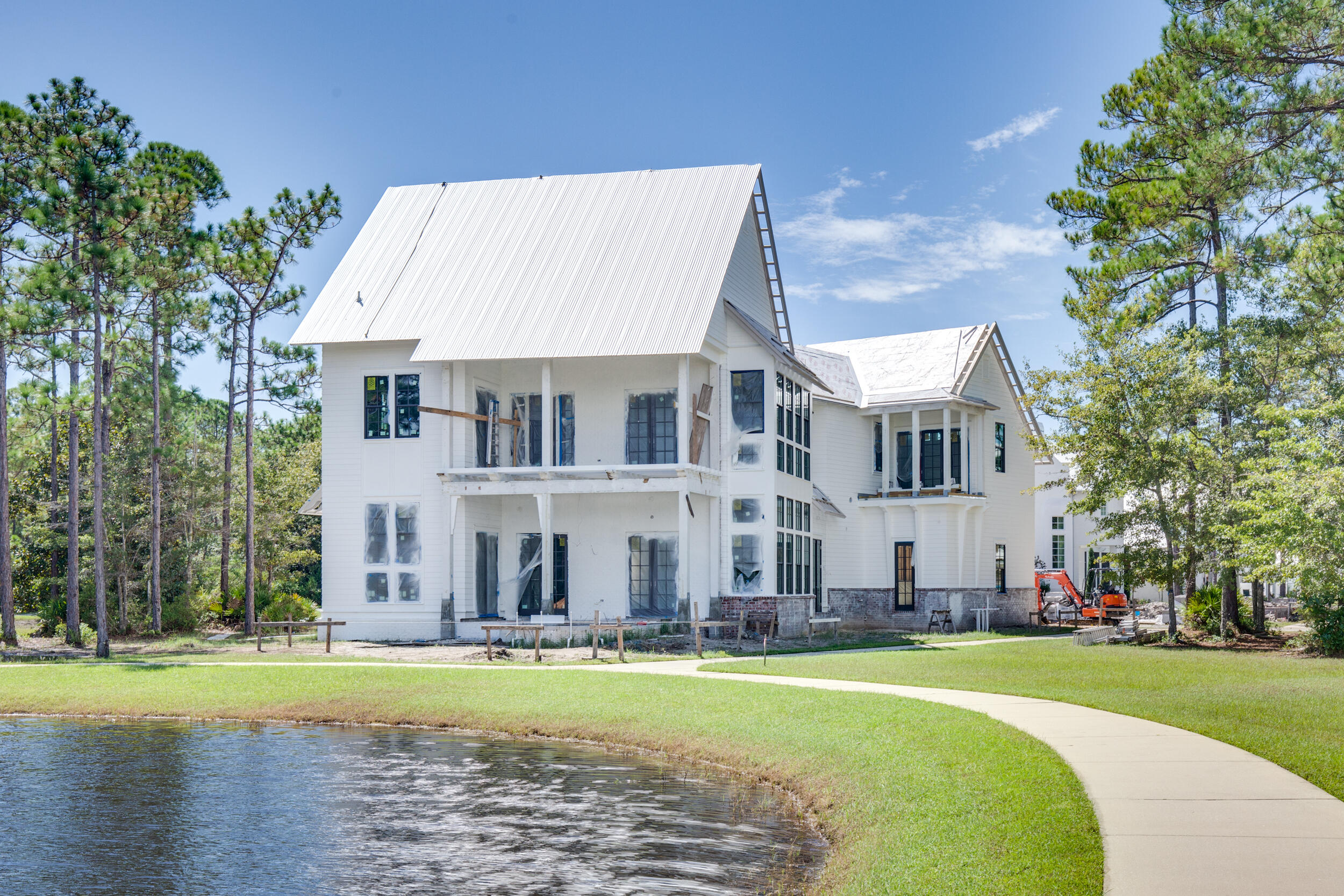 79 Perrin, Unit LOT 54 Santa Rosa Beach, FL 32459 - Photo 2 of 36 a view of a white house with a big yard and a large tree