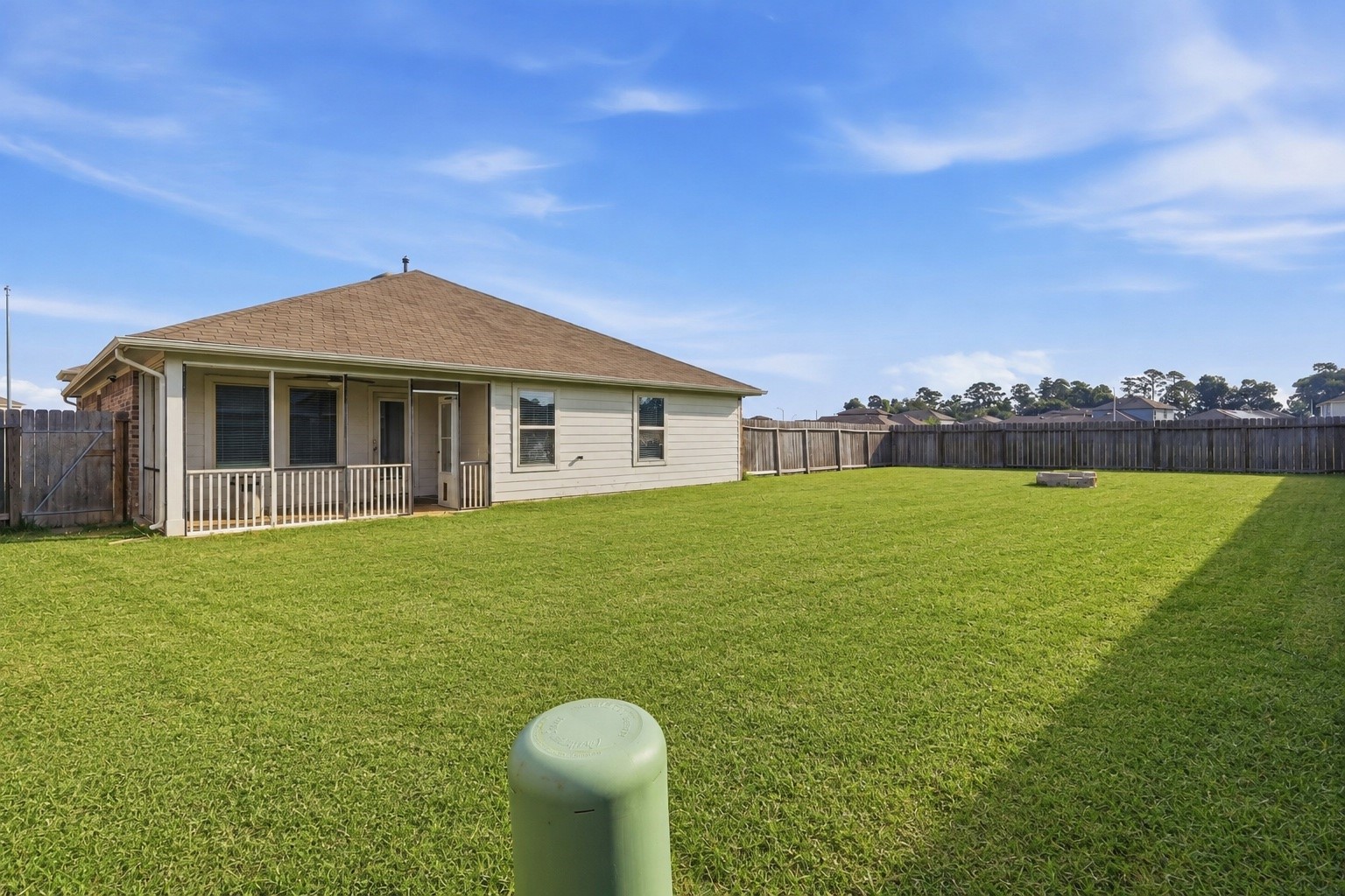 2346 Gold Forsythia Ln Spring Spring, TX 77373 - Photo 30 of 39 Large fenced backyard with open lawn space, an automatic in-ground irrigation system, and a fire pit area. The yard provides space for outdoor seating, play equipment, gardening, or pets.