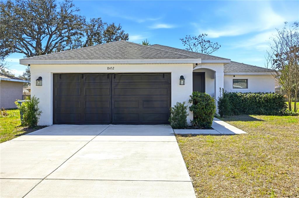 8452 Dorsey Street Spring Hill, FL 34608 - Photo 1 of 28 a front view of a house with yard