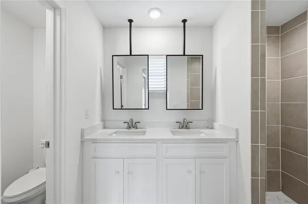 a bathroom with a double vanity sink and a mirror