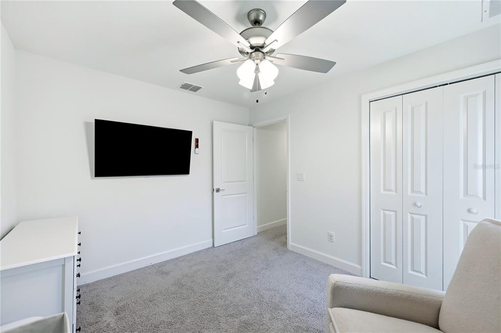 8452 Dorsey Street Spring Hill, FL 34608 - Photo 13 of 28 a living room with furniture and a flat screen tv