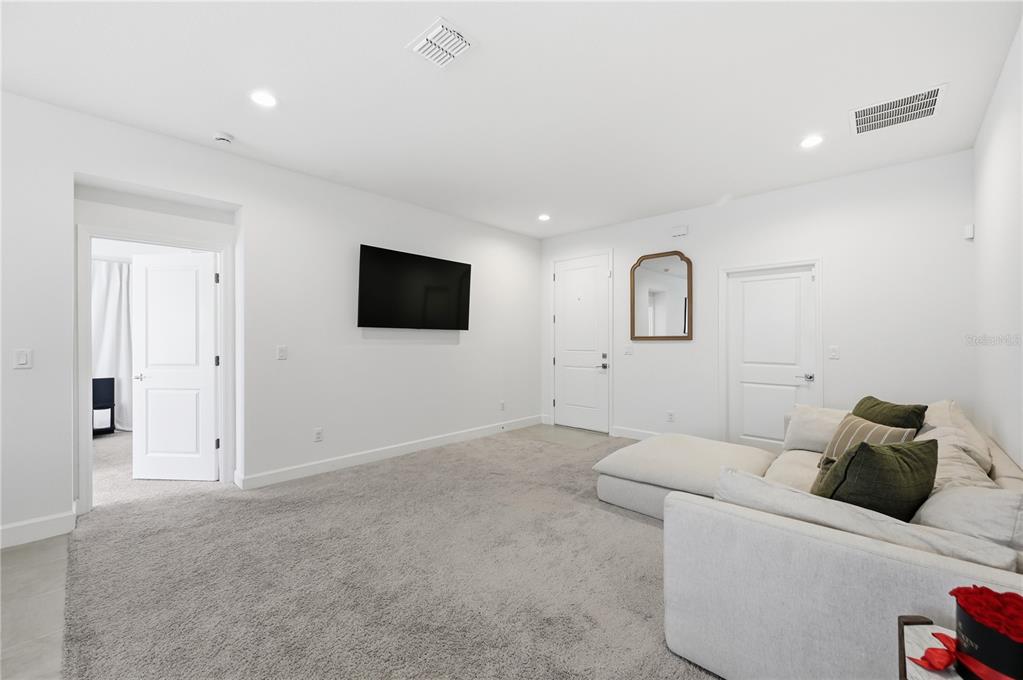 8452 Dorsey Street Spring Hill, FL 34608 - Photo 15 of 28 a living room with furniture and a flat screen tv