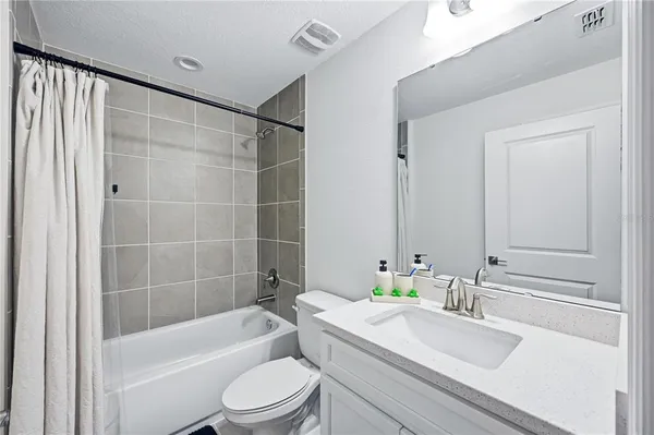 a bedroom with a bed and a desk