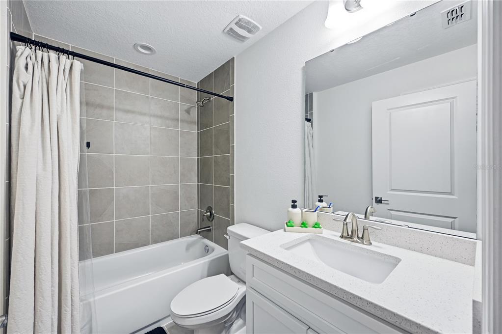 8452 Dorsey Street Spring Hill, FL 34608 - Photo 16 of 28 a bathroom with a sink a toilet a bathtub and shower