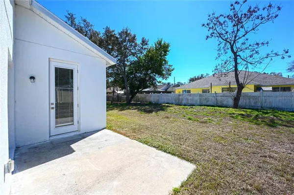 a view of a yard with a tree
