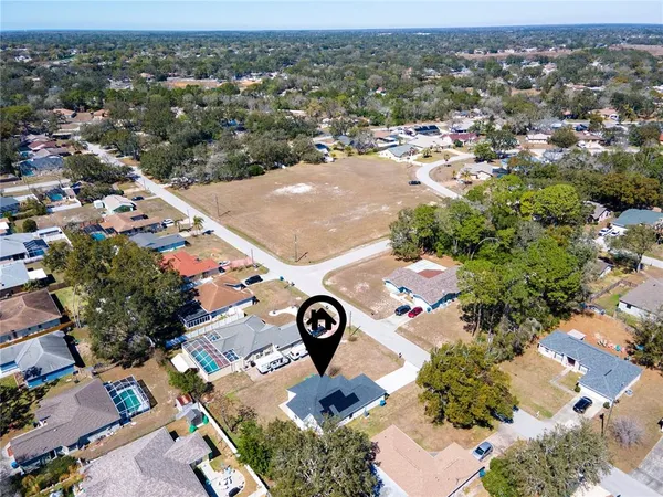 an aerial view of a house with swimming pool and mountain view
