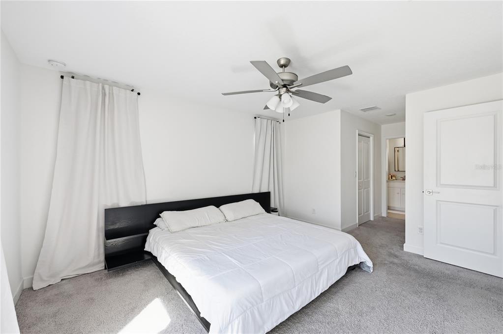 8452 Dorsey Street Spring Hill, FL 34608 - Photo 9 of 28 a bedroom with a bed and a chandelier