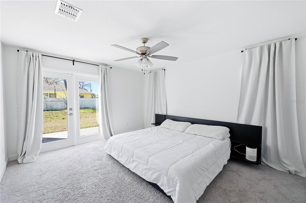 8452 Dorsey Street Spring Hill, FL 34608 - Photo 10 of 28 a bedroom with a bed and a chandelier