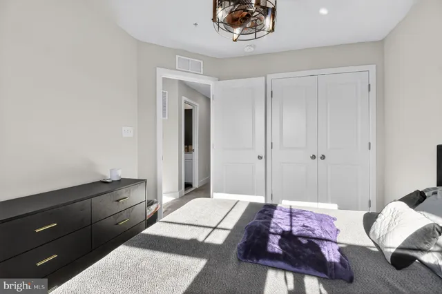 a spacious bedroom with a bed and a window