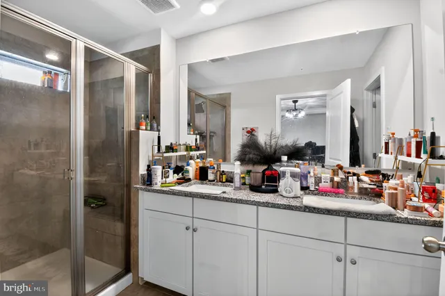 a bathroom with a double vanity sink and a mirror