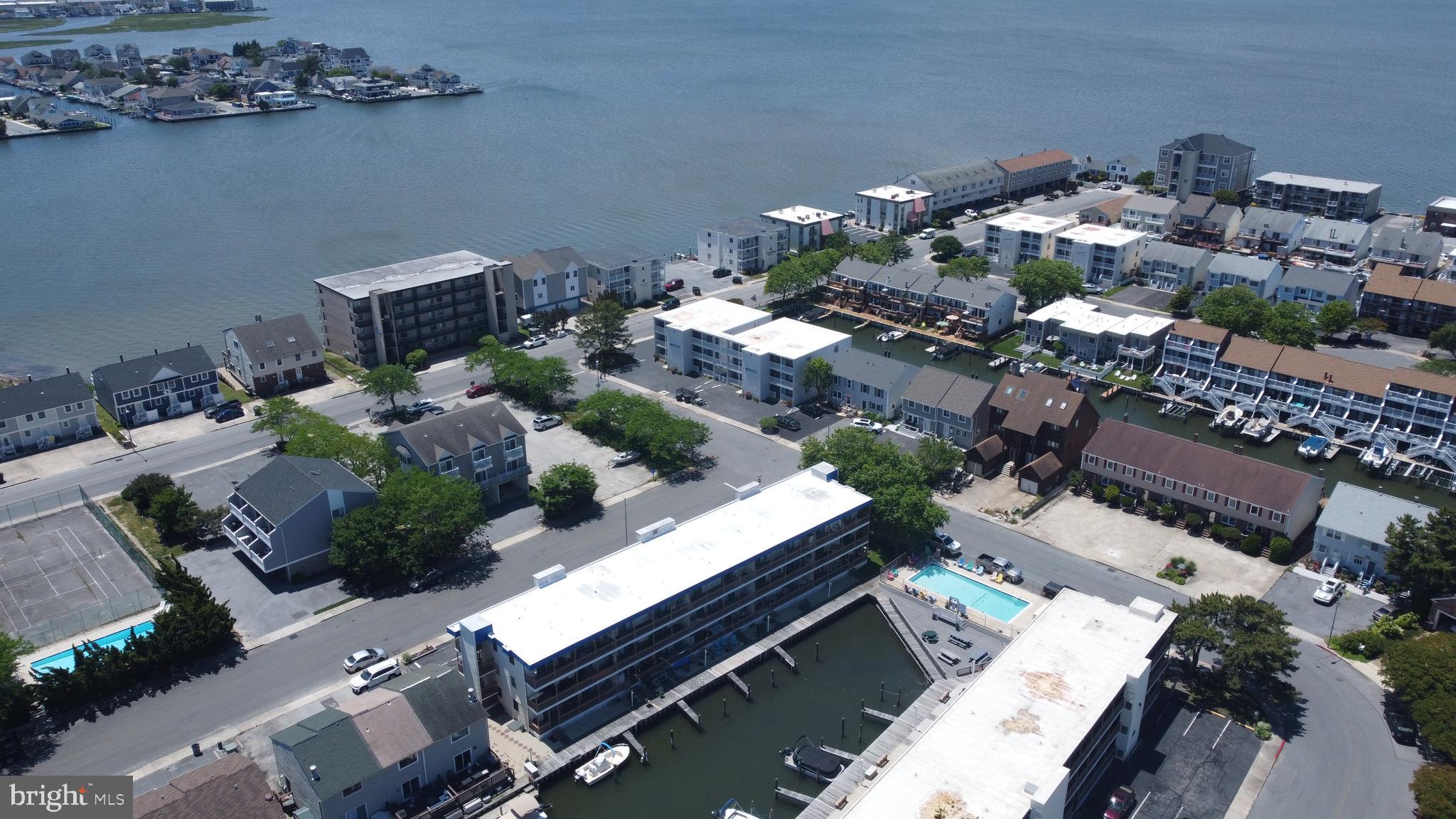 170 Captains Quarters Road, Unit 201 Ocean City, MD 21842 - Photo 19 of 65 an aerial view of a house with a yard and outdoor seating