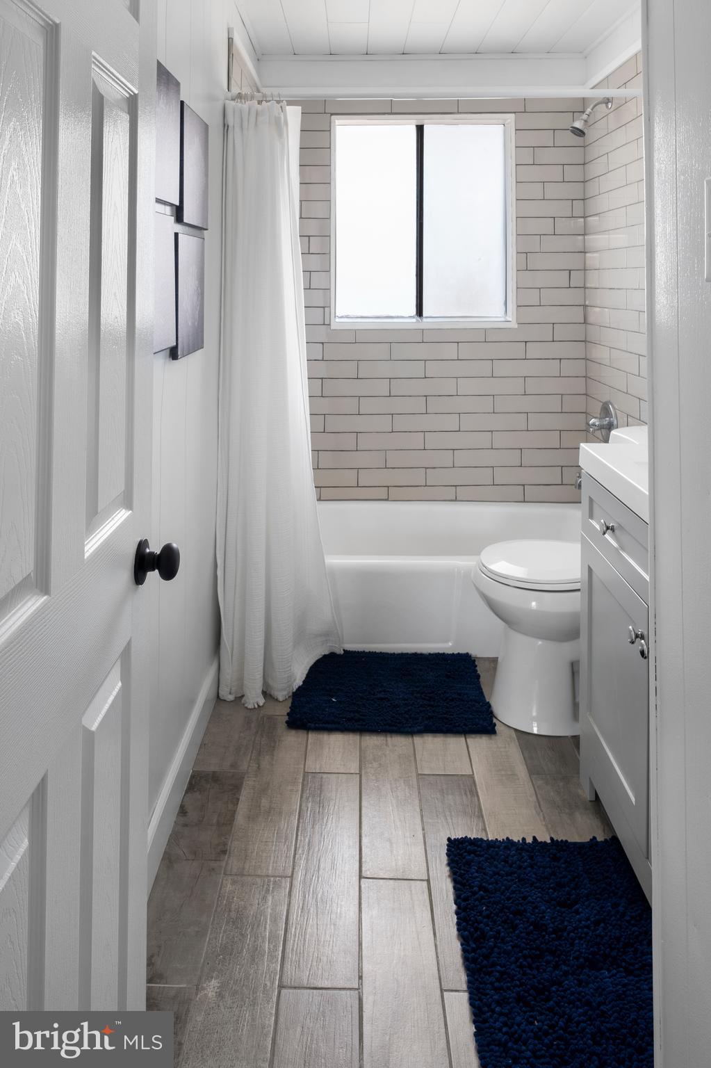 170 Captains Quarters Road, Unit 201 Ocean City, MD 21842 - Photo 20 of 65 a bathroom with a toilet a window and shower