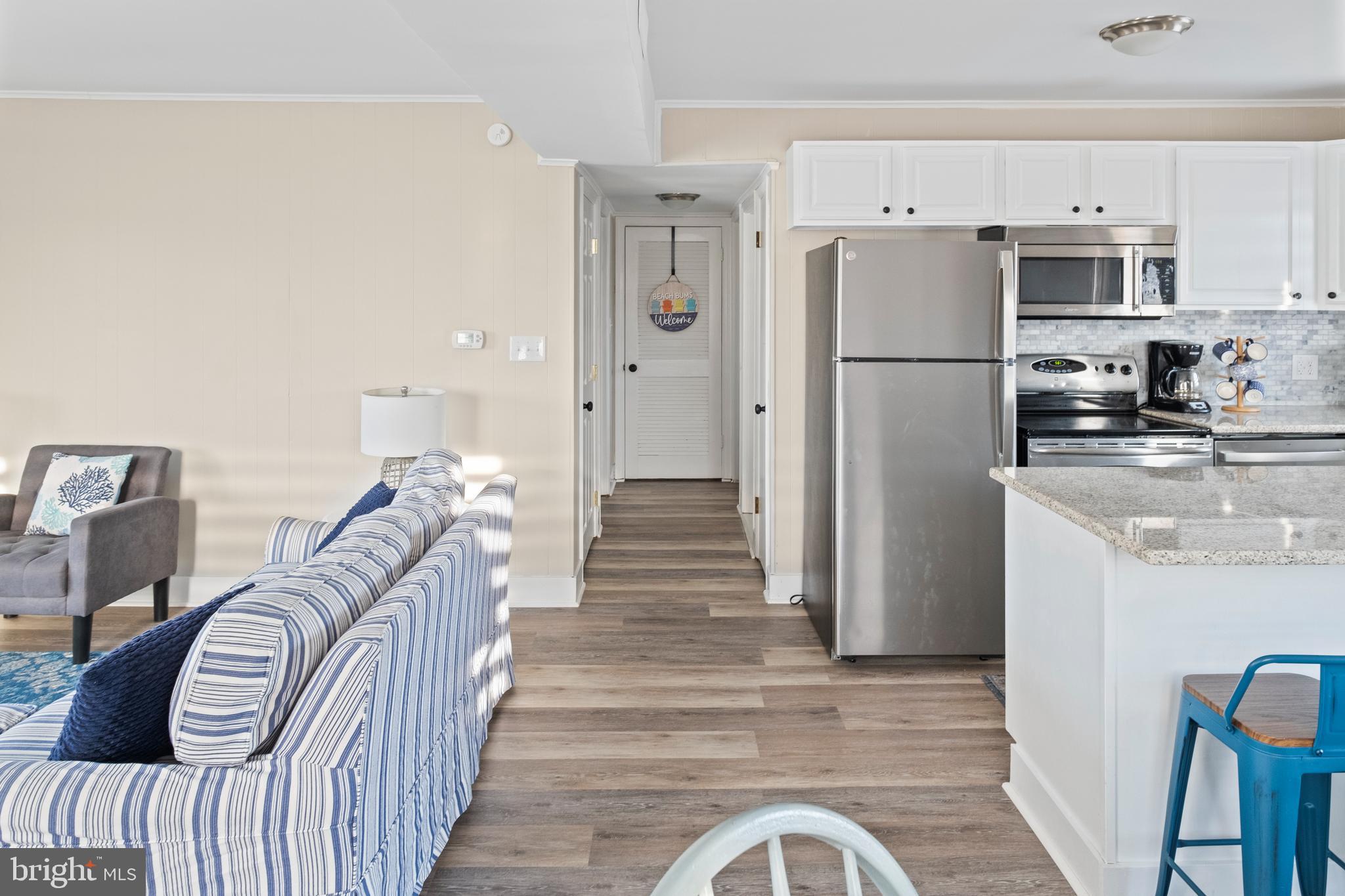170 Captains Quarters Road, Unit 201 Ocean City, MD 21842 - Photo 26 of 65 a view of a kitchen with refrigerator and wooden floor