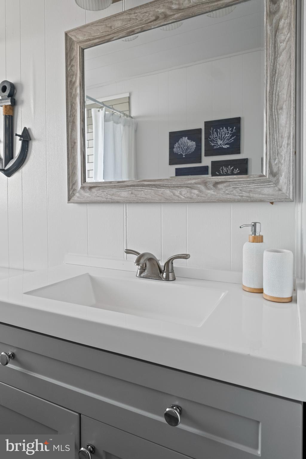 170 Captains Quarters Road, Unit 201 Ocean City, MD 21842 - Photo 29 of 65 a bathroom with a sink and a mirror