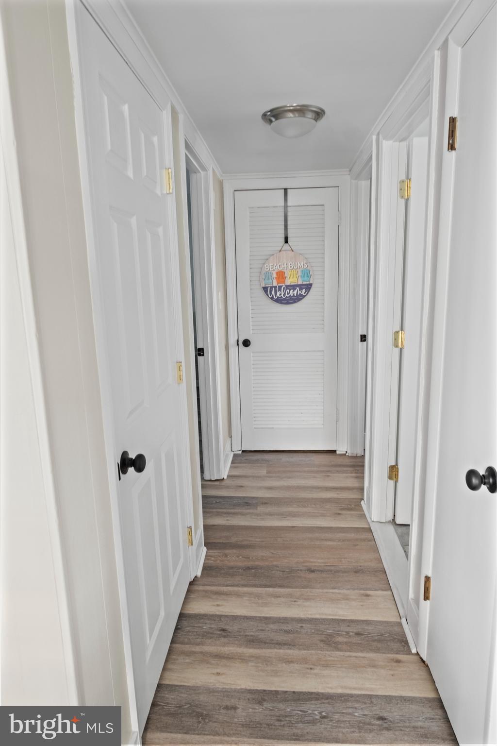 170 Captains Quarters Road, Unit 201 Ocean City, MD 21842 - Photo 35 of 65 a view of a hallway with wooden floor and entryway