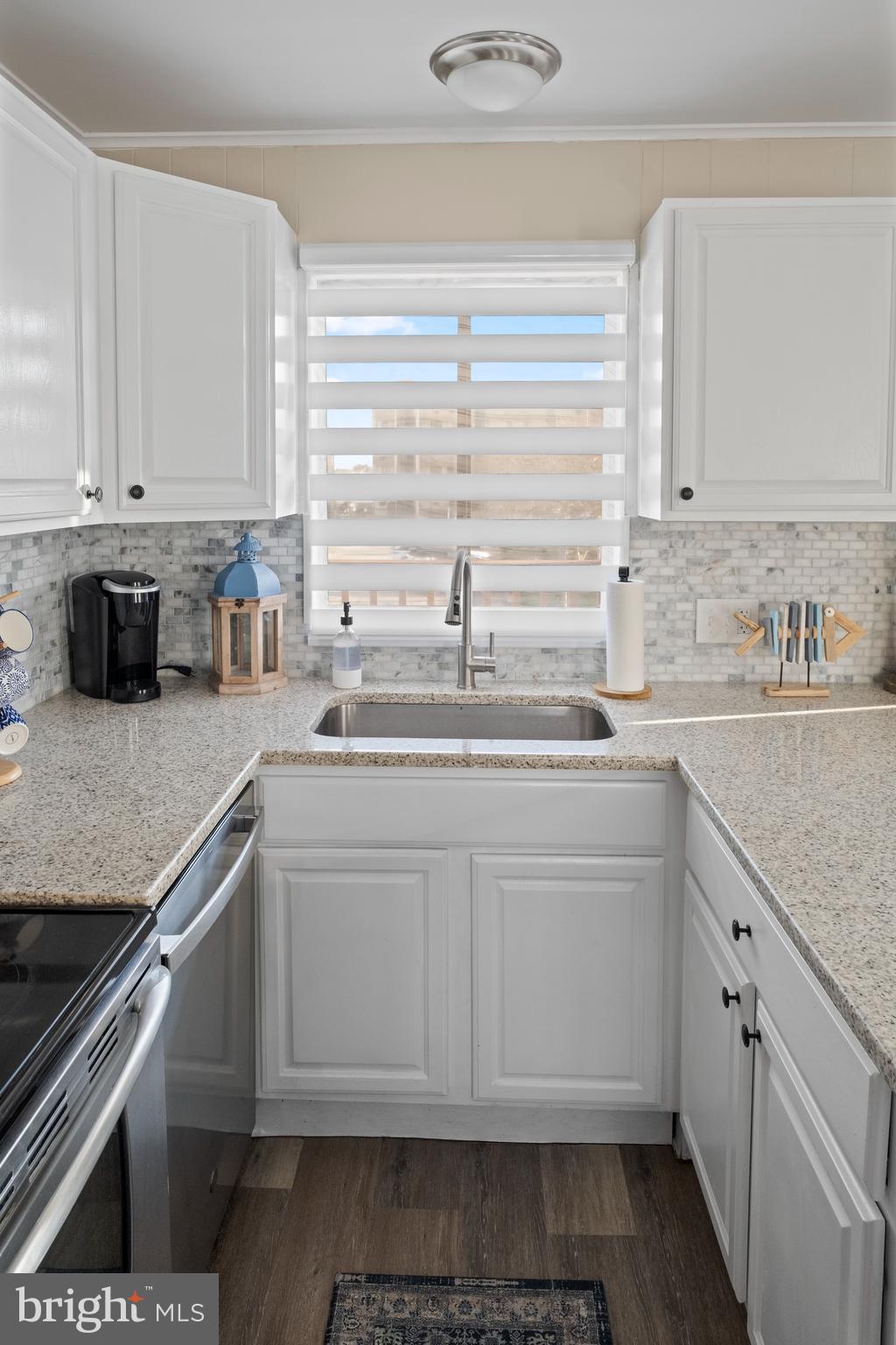 170 Captains Quarters Road, Unit 201 Ocean City, MD 21842 - Photo 36 of 65 a kitchen with granite countertop a sink and a stove