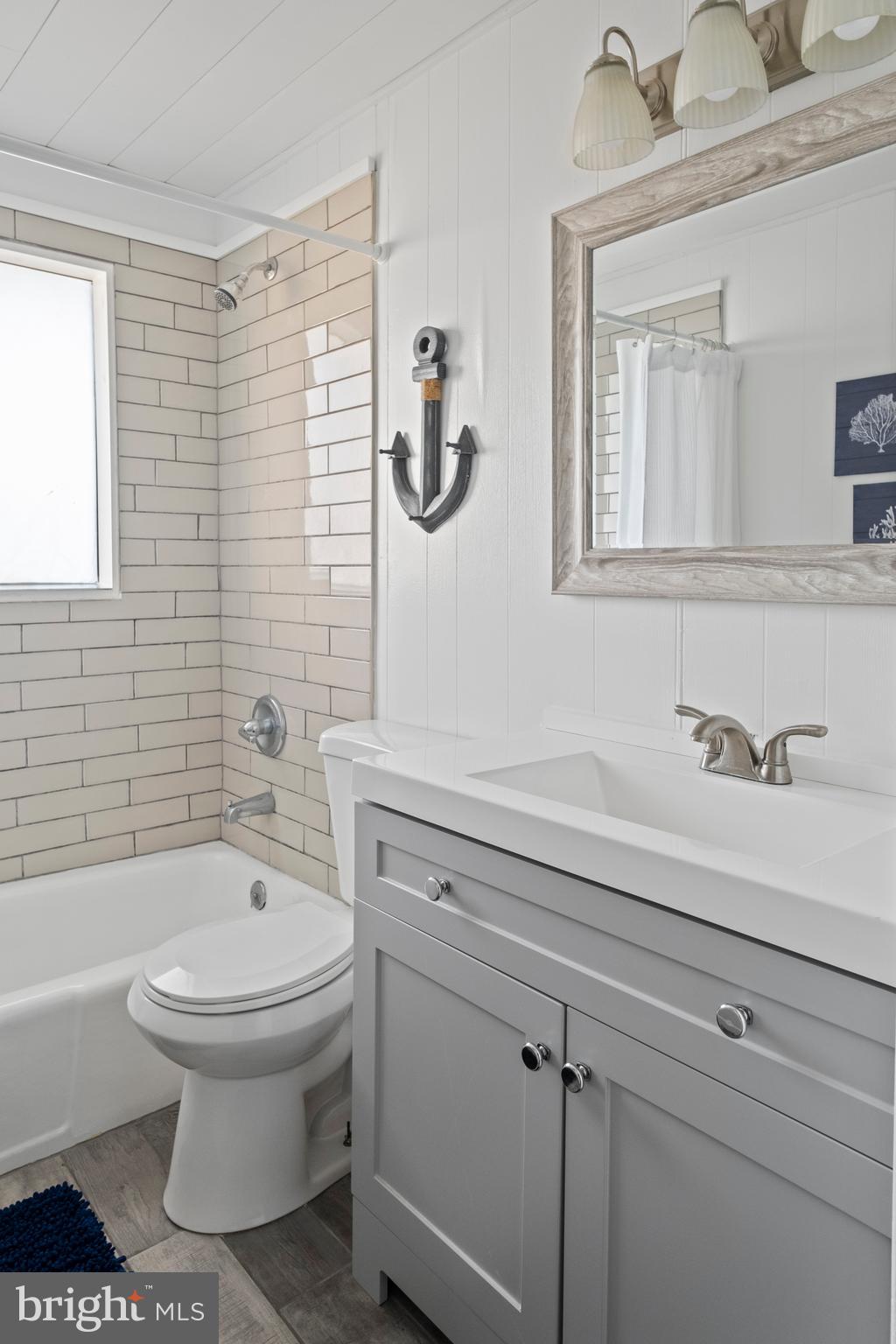 170 Captains Quarters Road, Unit 201 Ocean City, MD 21842 - Photo 37 of 65 a bathroom with a sink a toilet and a mirror