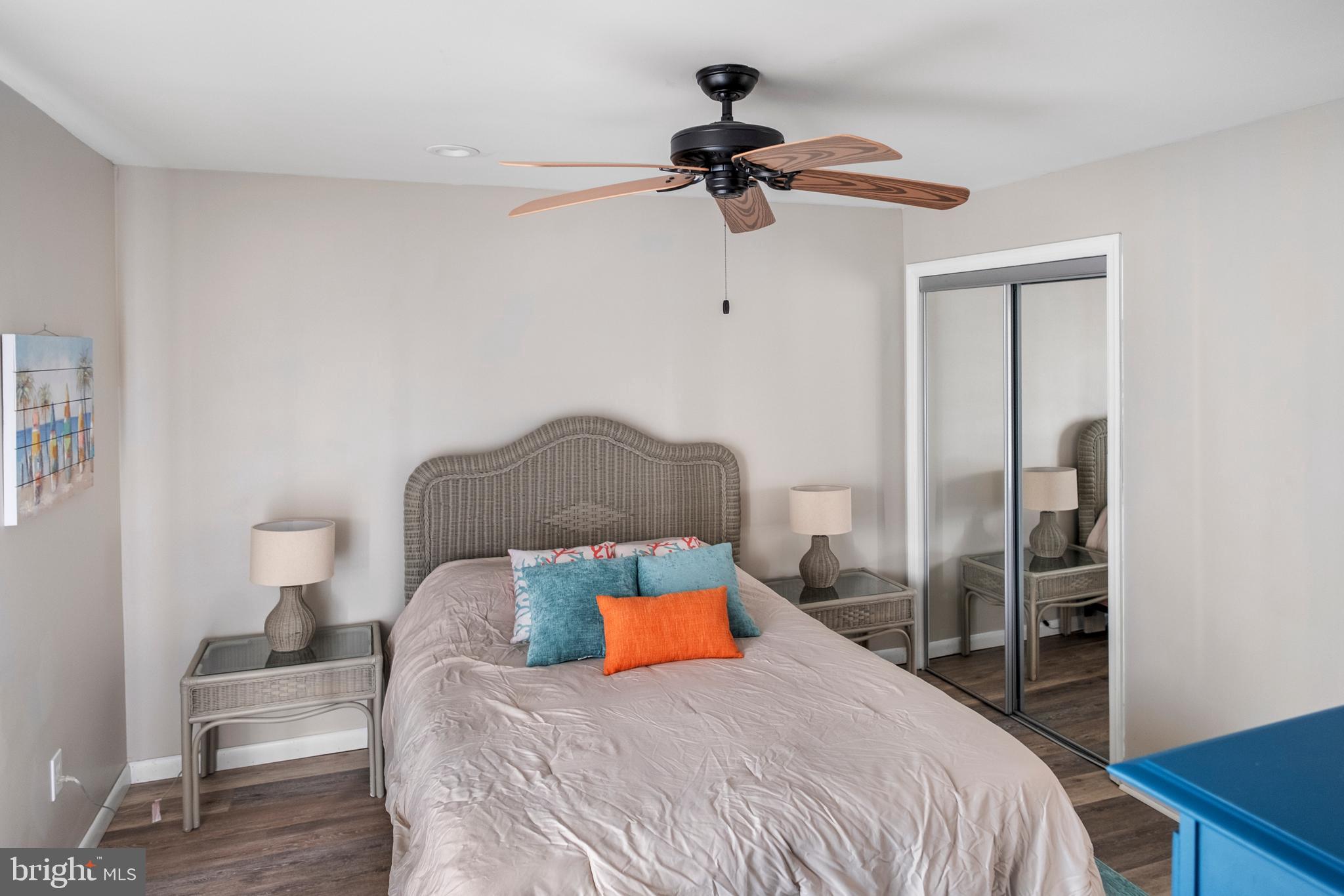 170 Captains Quarters Road, Unit 201 Ocean City, MD 21842 - Photo 39 of 65 a bedroom with a bed and a chandelier