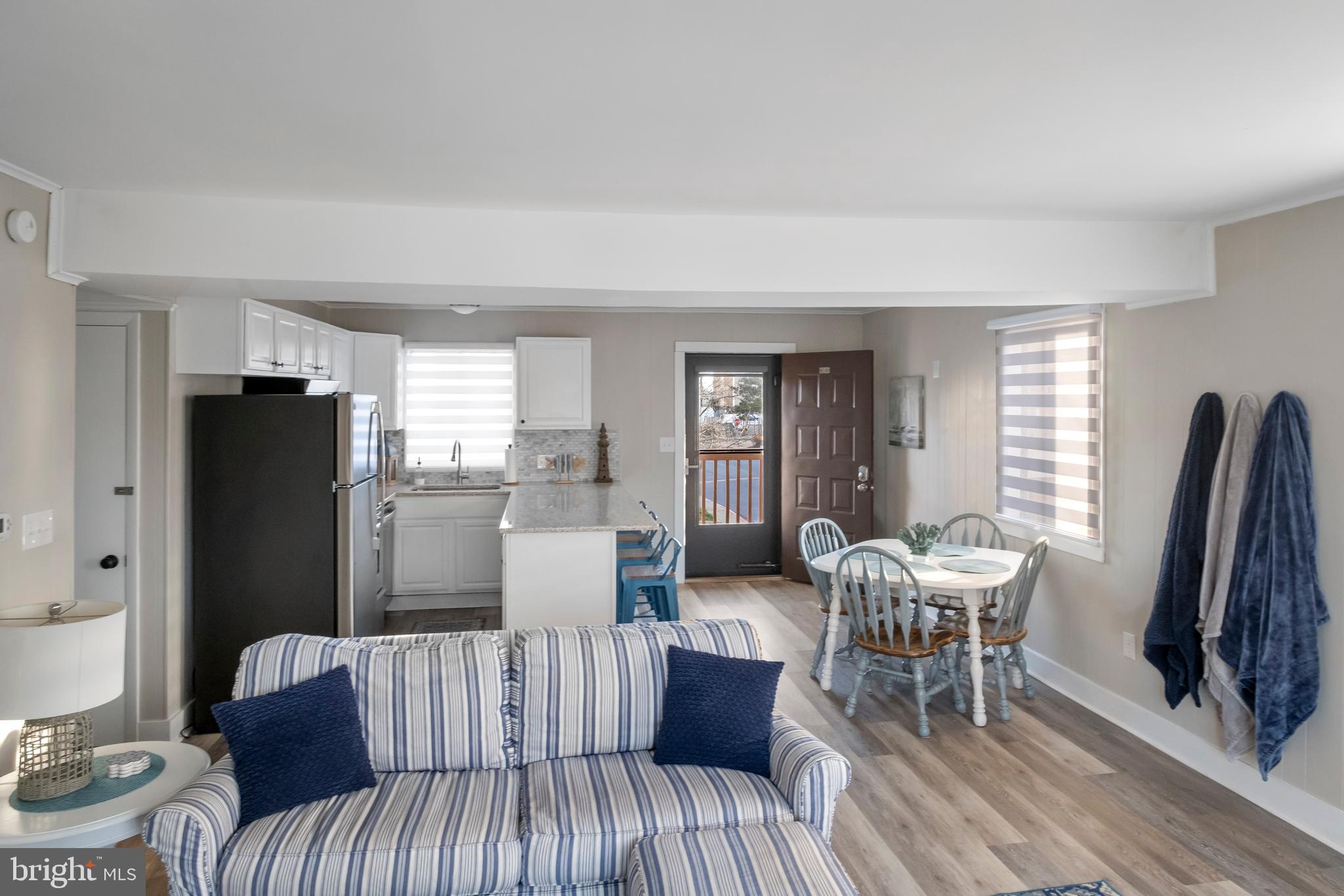 170 Captains Quarters Road, Unit 201 Ocean City, MD 21842 - Photo 40 of 65 a living room with furniture and a flat screen tv
