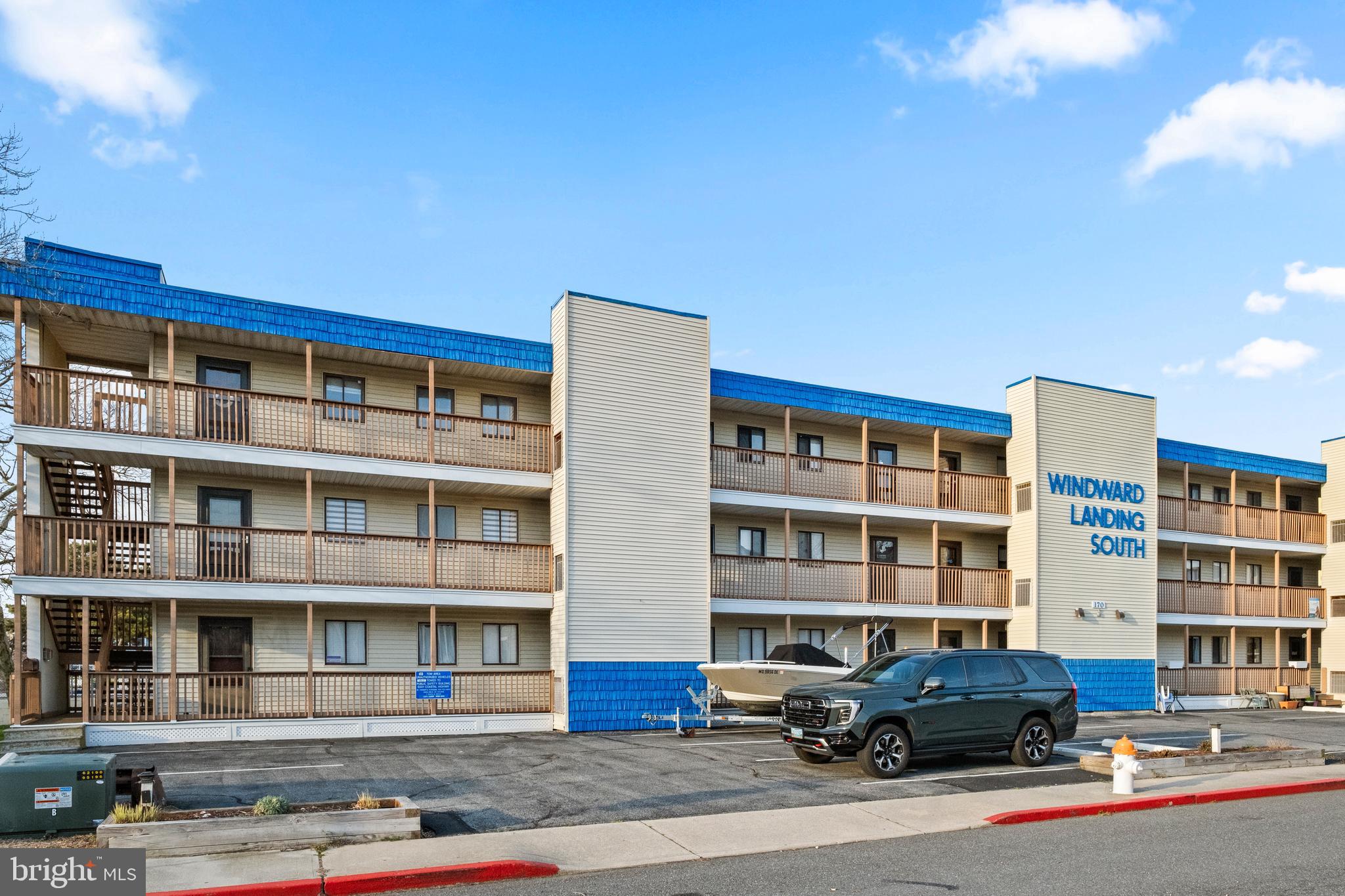 170 Captains Quarters Road, Unit 201 Ocean City, MD 21842 - Photo 41 of 65 a front view of a building with lot of cars and trees