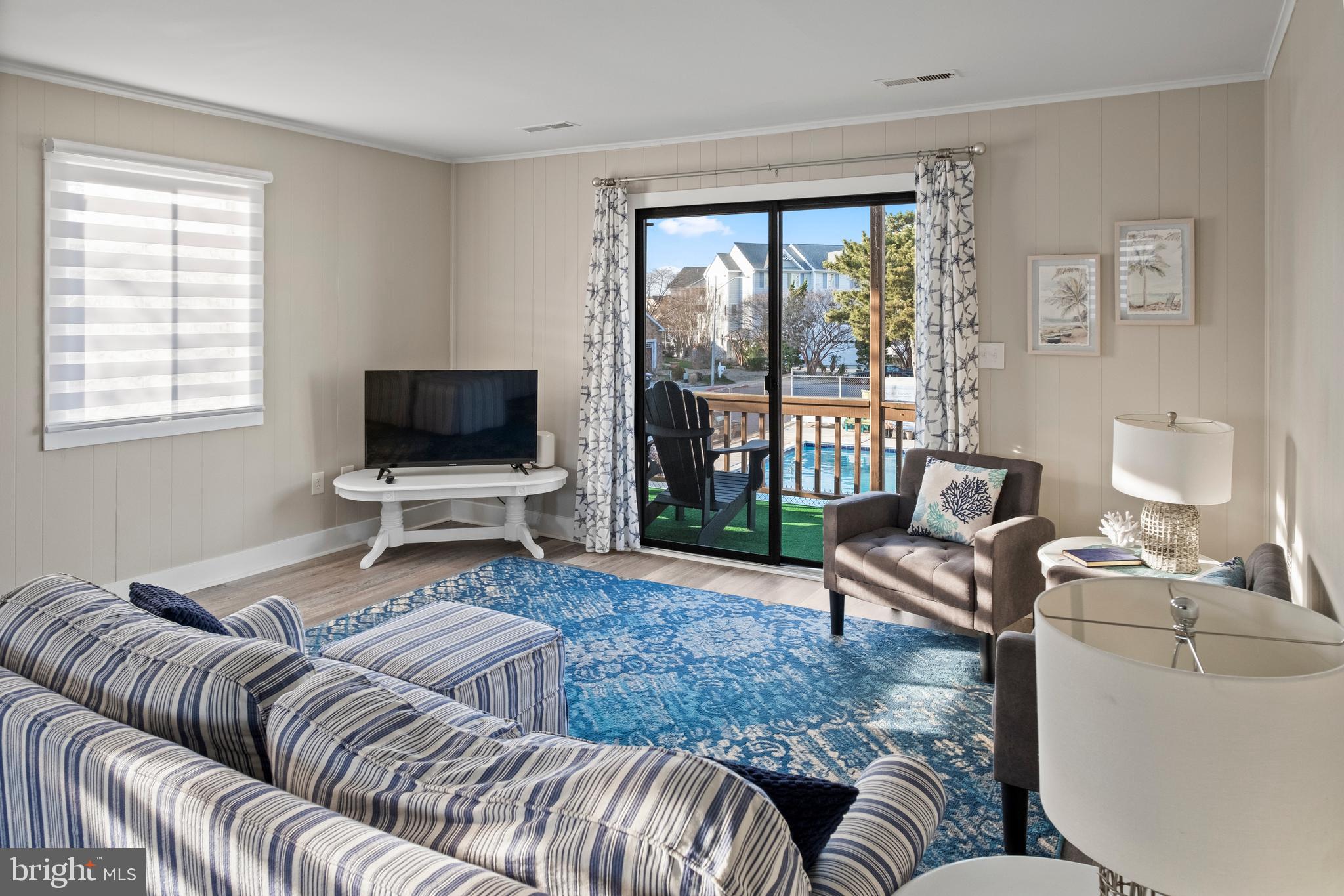 170 Captains Quarters Road, Unit 201 Ocean City, MD 21842 - Photo 45 of 65 a living room with furniture and a flat screen tv